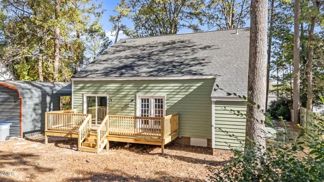 a view of a house with a yard and wooden fence
