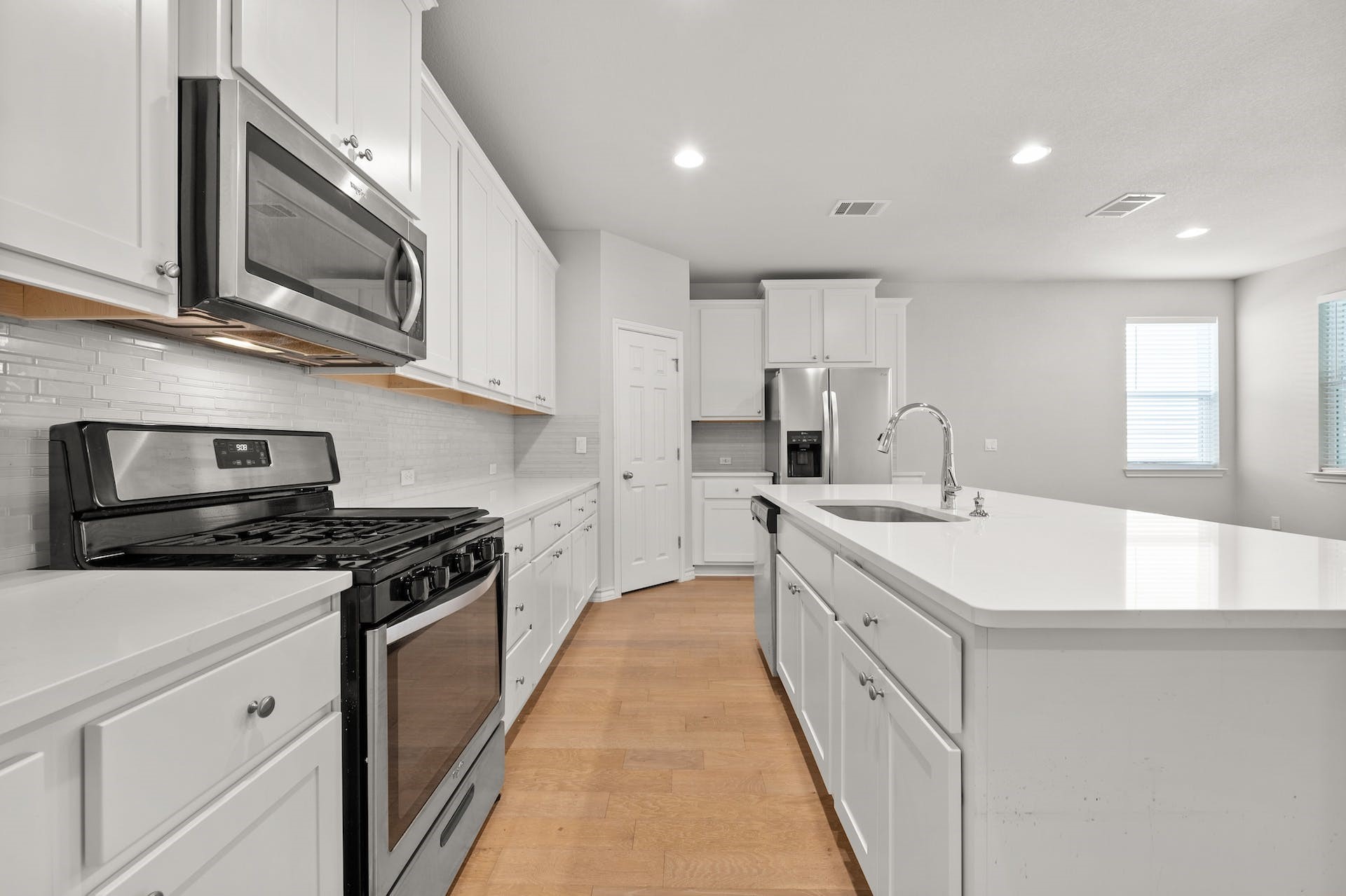 5107 Lemon Tree Path, Unit 127 Austin, TX 78723 - Photo 10 of 40 a kitchen with stainless steel appliances granite countertop a sink stove oven and white cabinets