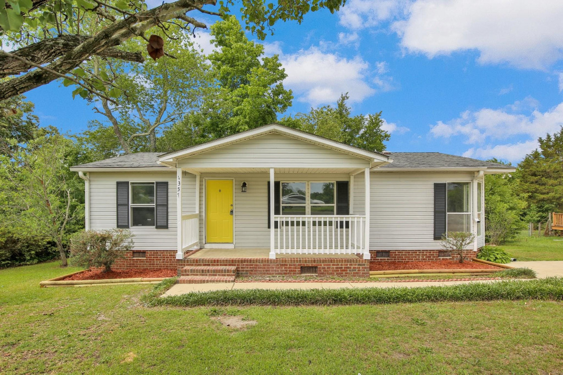 1357 Heritage Way Cameron, NC 28326 - Photo 1 of 28 a front view of a house with a garden