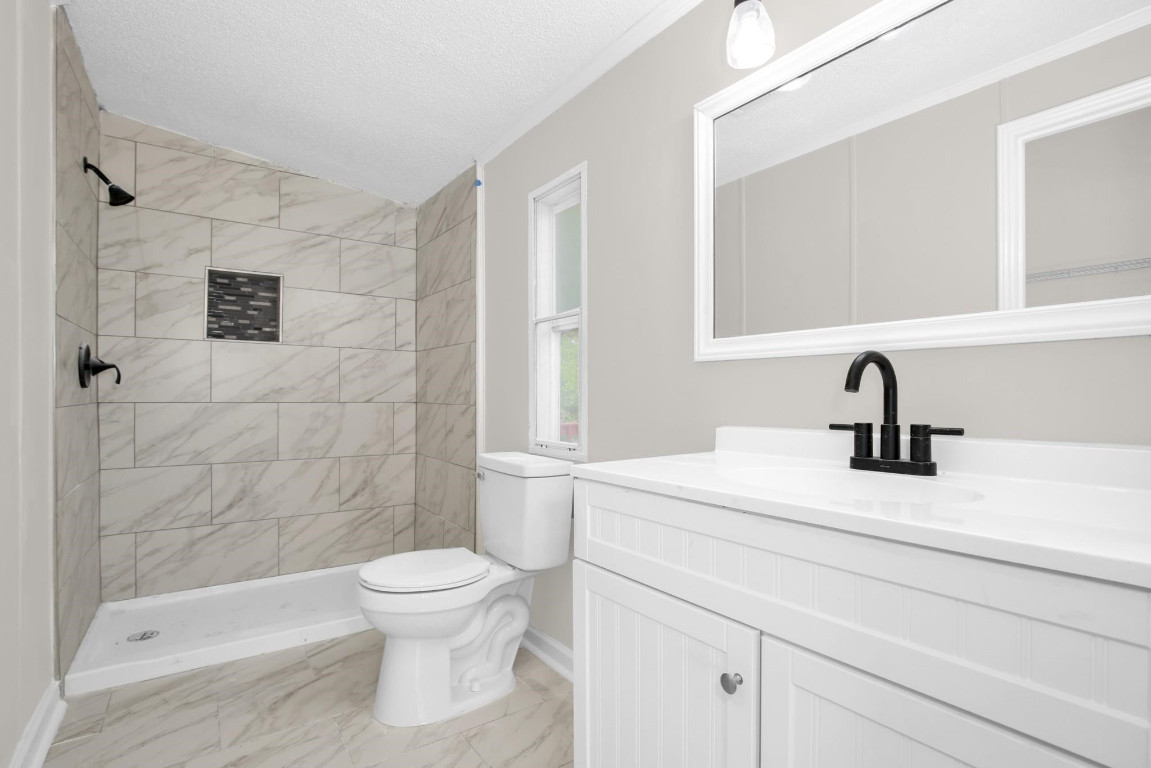 1357 Heritage Way Cameron, NC 28326 - Photo 17 of 28 a bathroom with a sink toilet a mirror and shower