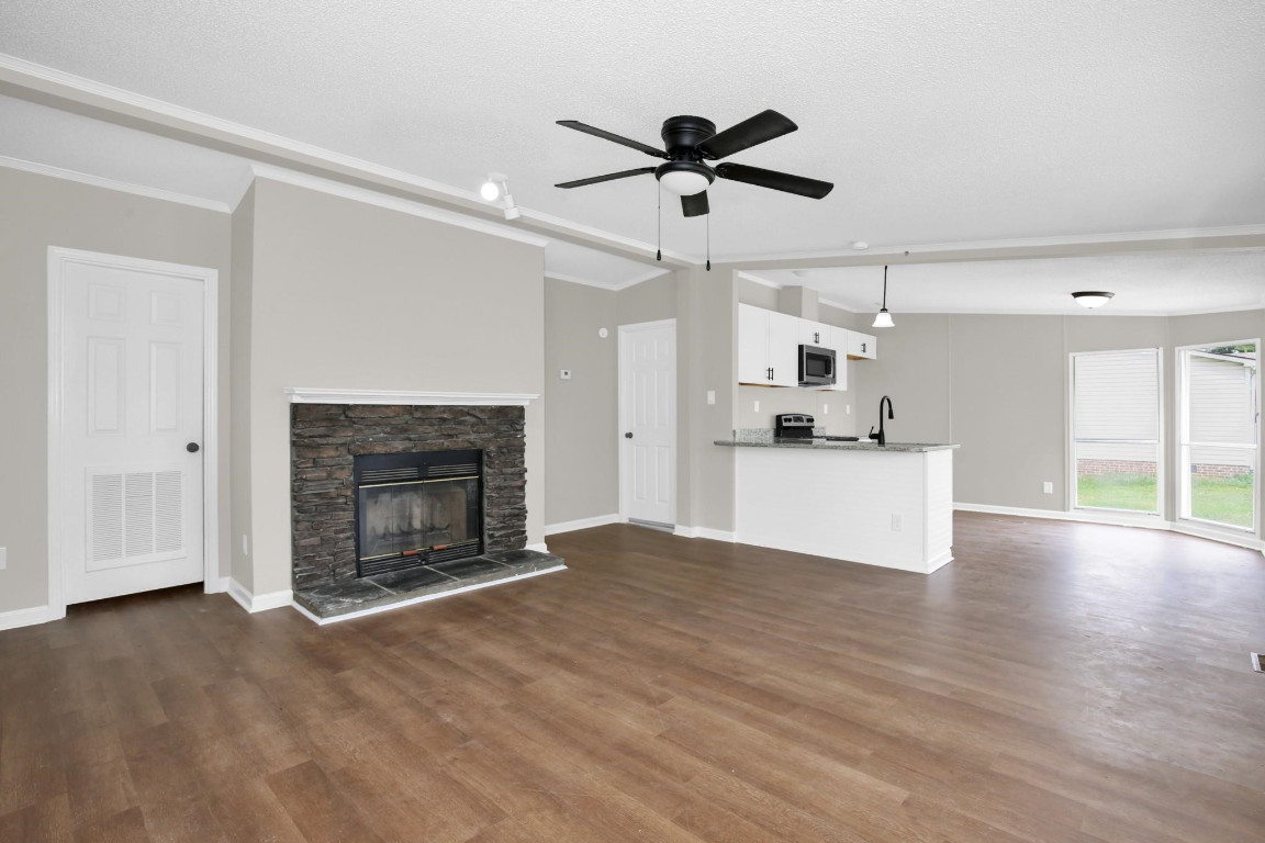 1357 Heritage Way Cameron, NC 28326 - Photo 4 of 28 a view of a kitchen with a sink a fireplace and a window