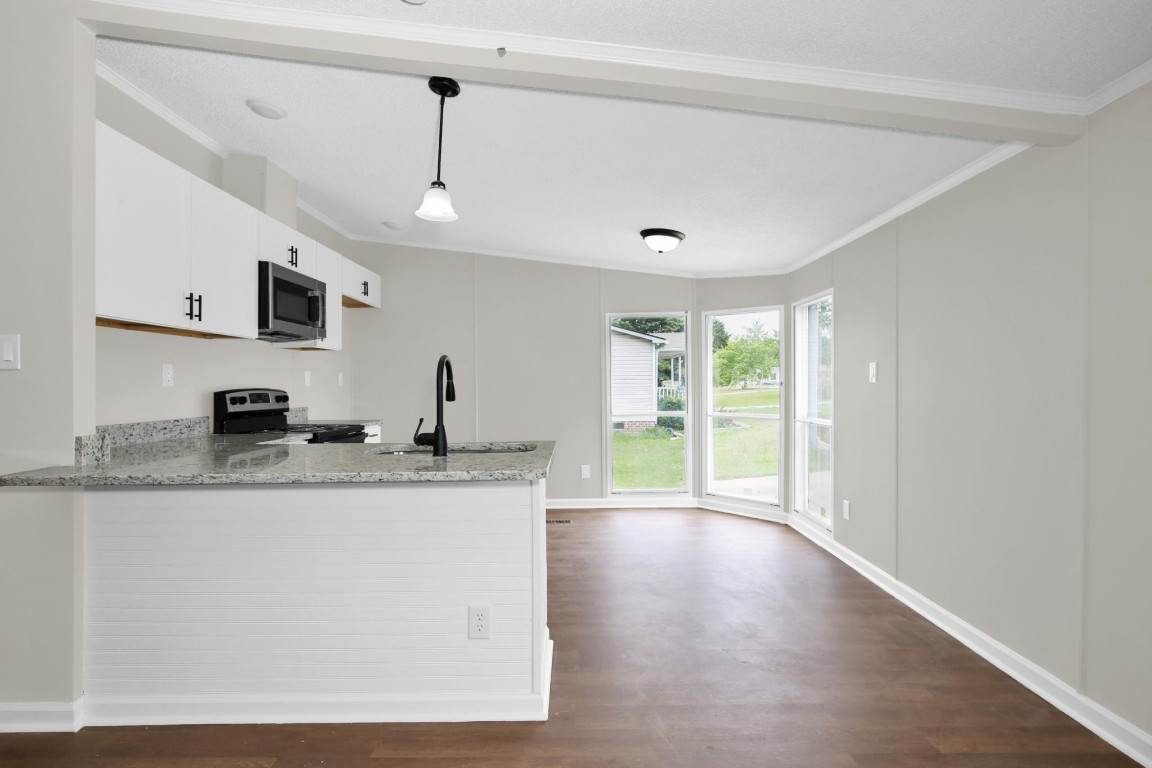 1357 Heritage Way Cameron, NC 28326 - Photo 9 of 28 a kitchen with stainless steel appliances granite countertop a sink a stove and a refrigerator