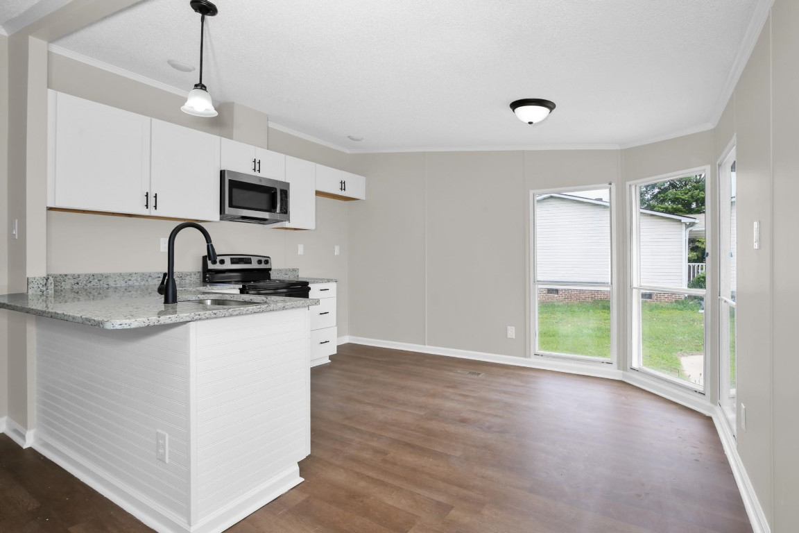 1357 Heritage Way Cameron, NC 28326 - Photo 10 of 28 a kitchen with sink a window and a glass door