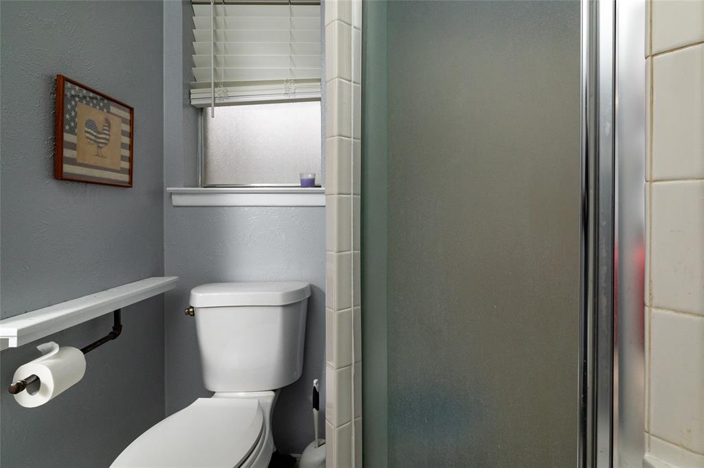 6020 Harrison Way Watauga, TX 76148 - Photo 24 of 32 Bathroom featuring a stall shower and a textured wall