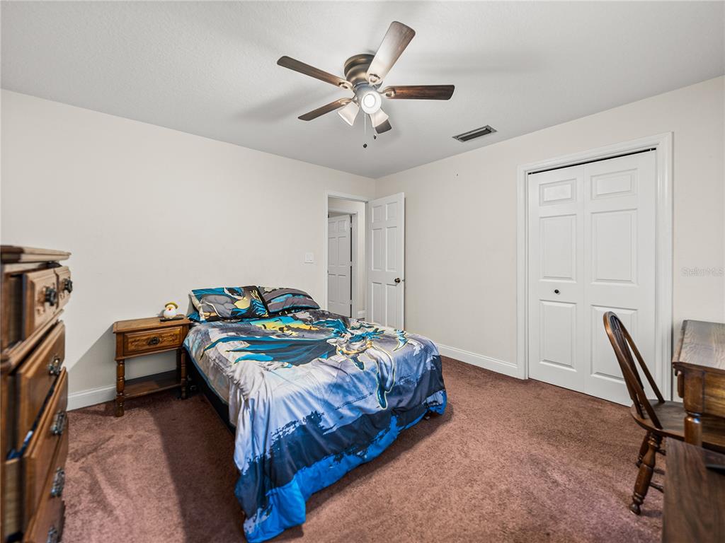 609 West Pipkin Road Lakeland, FL 33813 - Photo 36 of 72 a bedroom with a bed and a chandelier