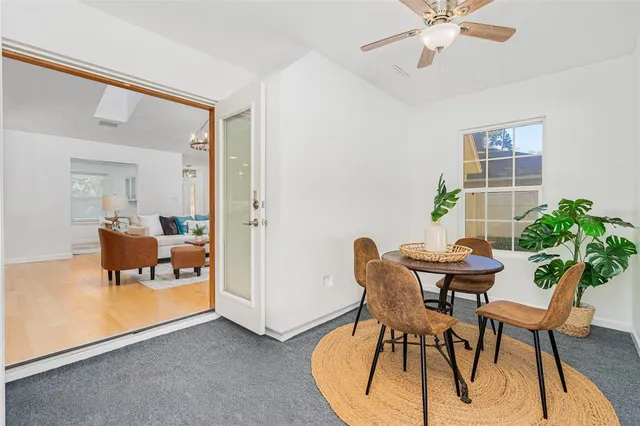 a view of a dining room with furniture and a window
