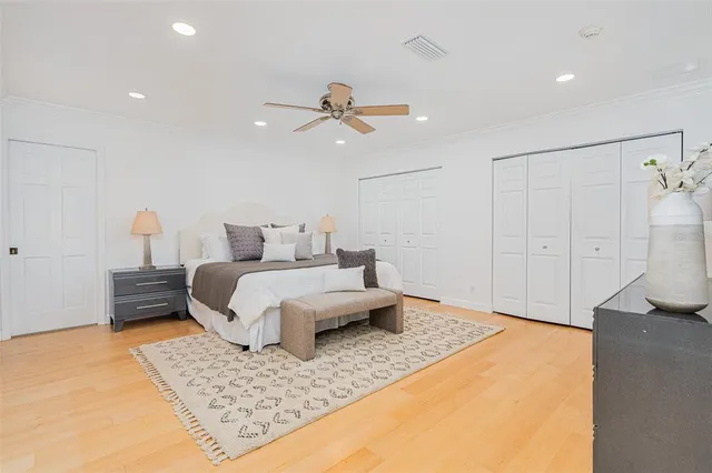 a bedroom with a bed and a lamp on the dresser