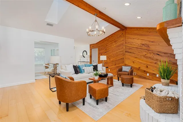 a living room with patio furniture and a rug