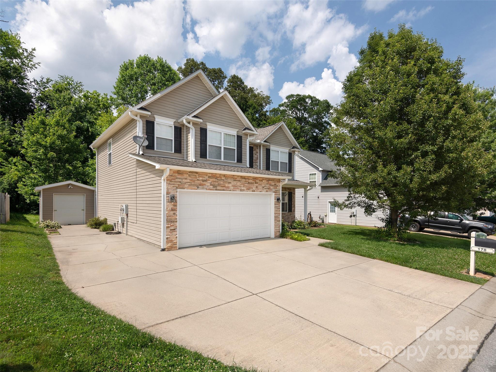 178 Black River Road Fletcher, NC 28732 - Photo 2 of 19 a front view of a house with a yard and garage
