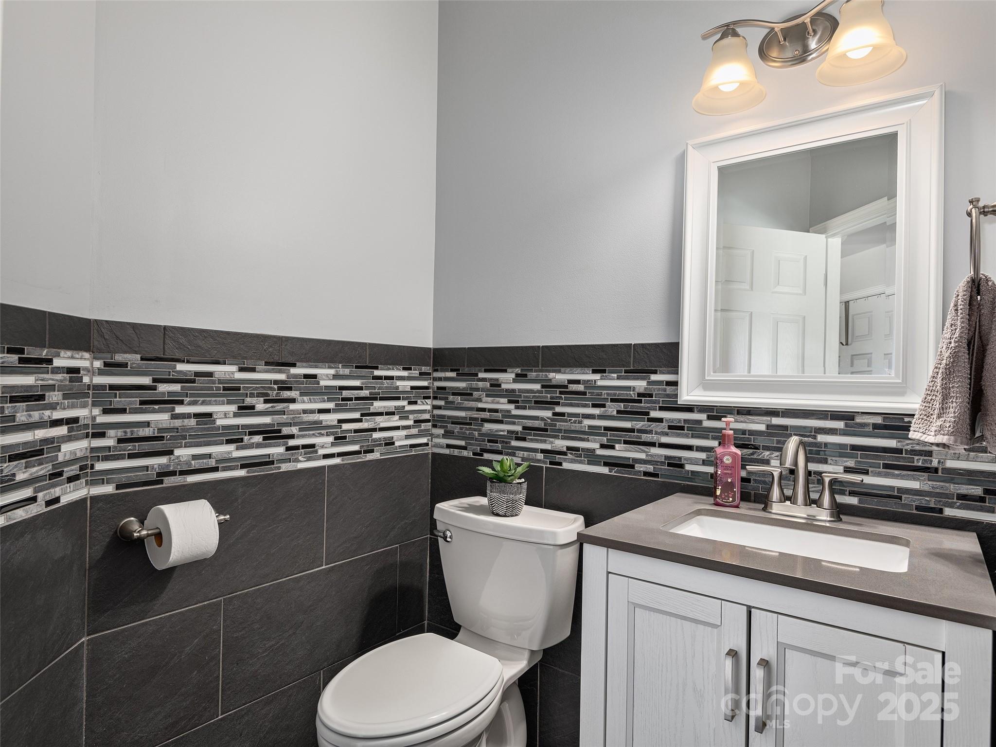 178 Black River Road Fletcher, NC 28732 - Photo 9 of 19 a bathroom with a granite countertop toilet sink and mirror