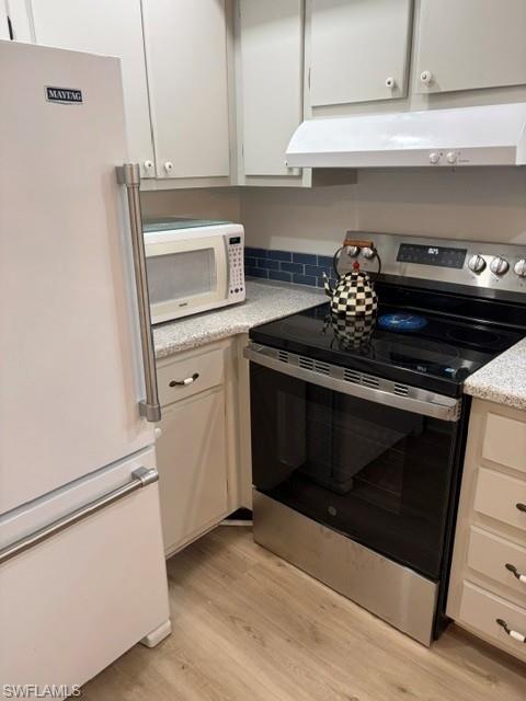 5 High Point Circle West, Unit 206 Naples, FL 34103 - Photo 37 of 39 a stove top oven sitting inside of a kitchen