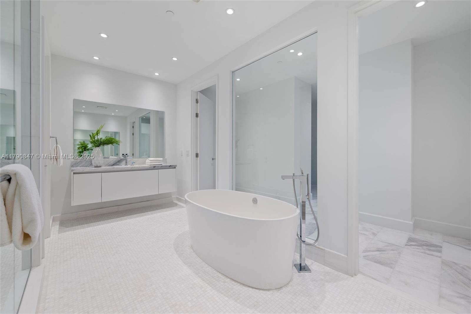 700 Northeast 26th Terrace, Unit TH403 Miami, FL 33137 - Photo 23 of 85 a bathroom with a bathtub a window a sink and a shower