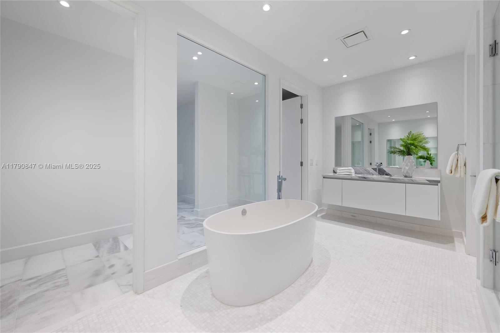 700 Northeast 26th Terrace, Unit TH403 Miami, FL 33137 - Photo 24 of 85 a bathroom with a bathtub sink and mirror