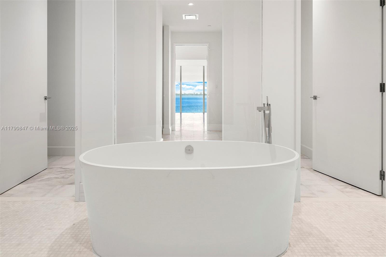 700 Northeast 26th Terrace, Unit TH403 Miami, FL 33137 - Photo 26 of 85 a white bath tub sitting in a bathroom