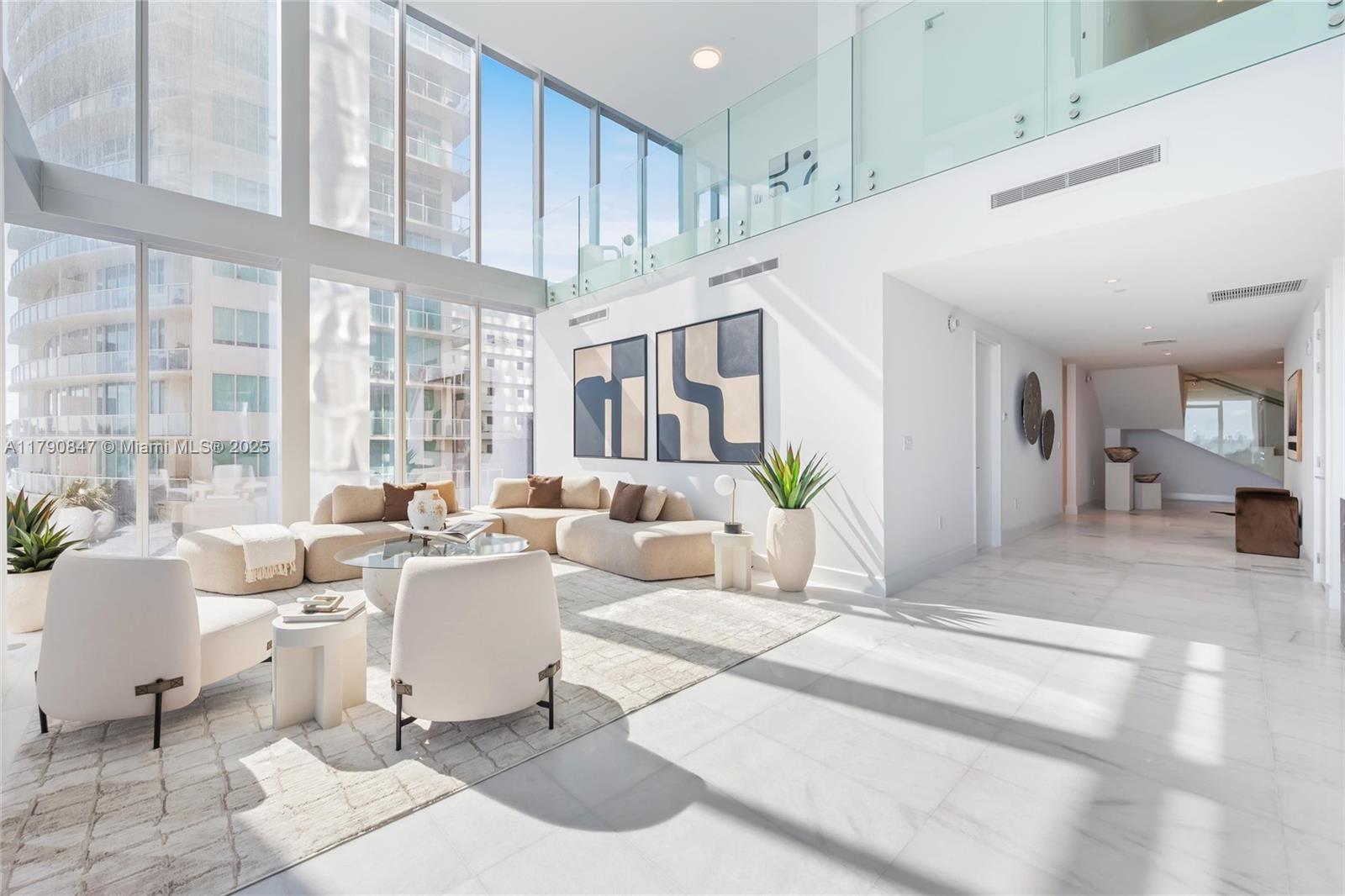 700 Northeast 26th Terrace, Unit TH403 Miami, FL 33137 - Photo 3 of 85 a living room with patio furniture and a large window