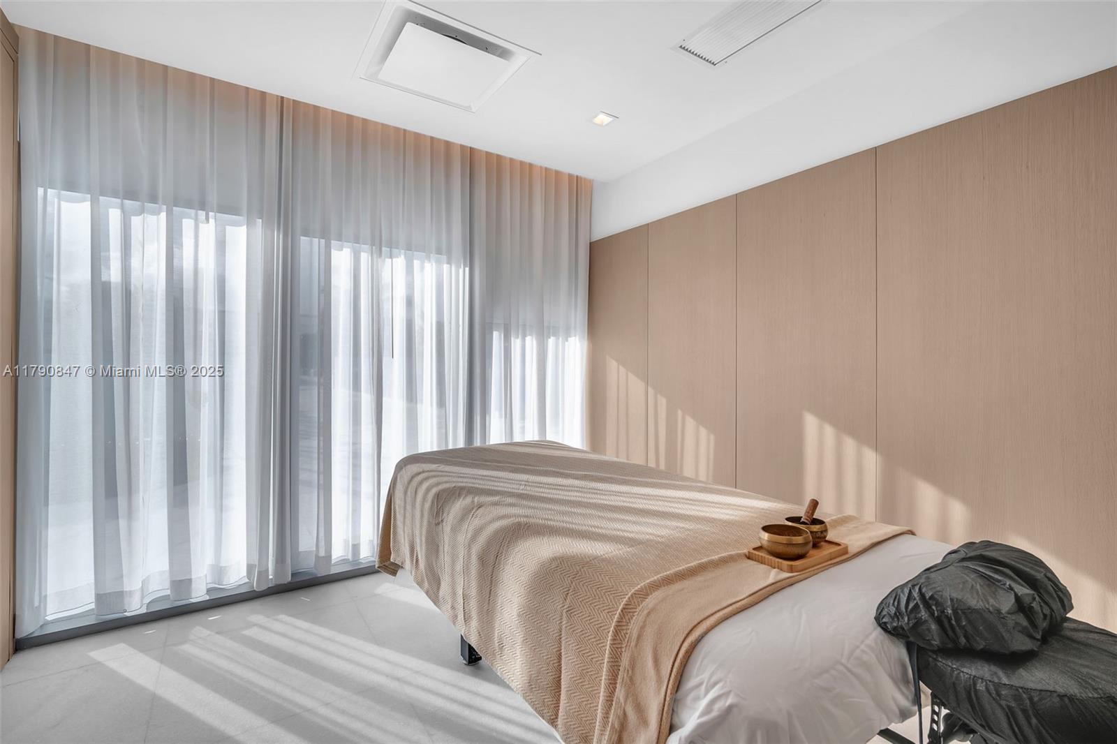 700 Northeast 26th Terrace, Unit TH403 Miami, FL 33137 - Photo 64 of 85 a bedroom with a bed and a window