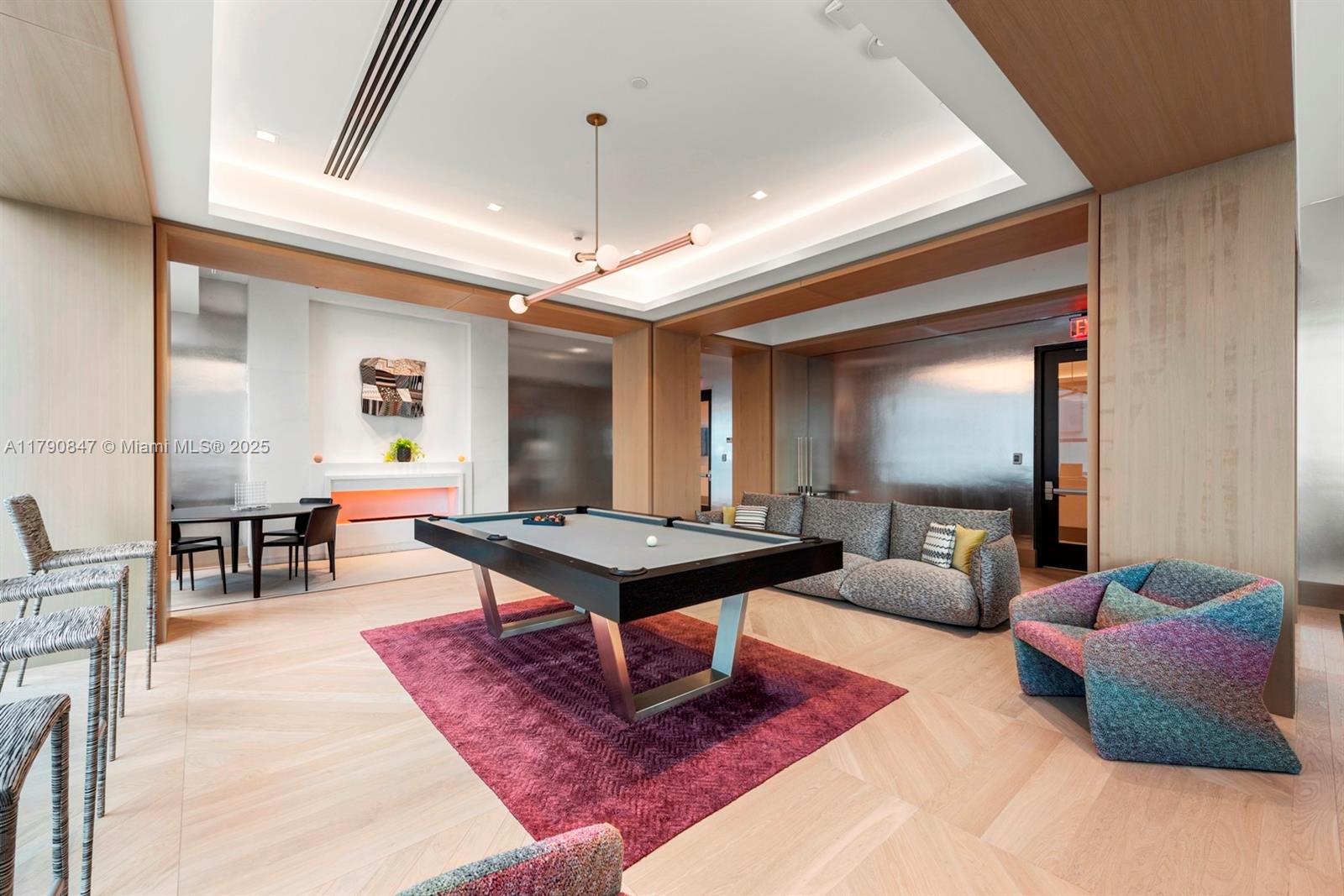 700 Northeast 26th Terrace, Unit TH403 Miami, FL 33137 - Photo 67 of 85 a living room with furniture a rug and a chandelier