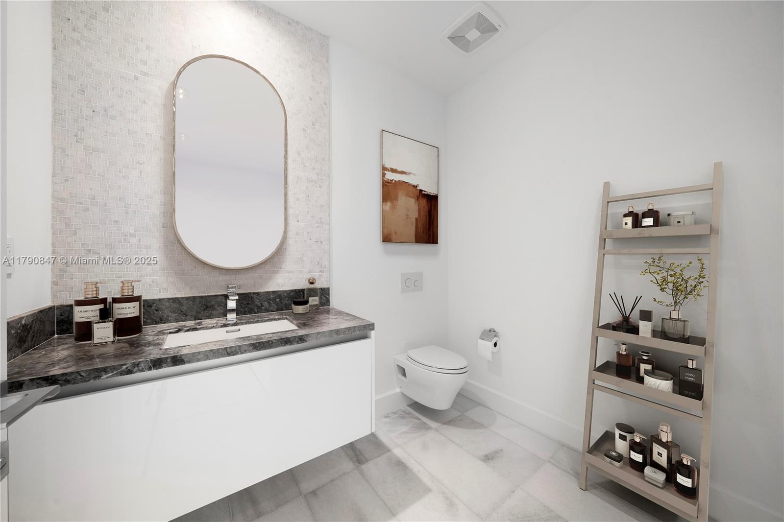 700 Northeast 26th Terrace, Unit TH403 Miami, FL 33137 - Photo 7 of 85 a bathroom with a granite countertop toilet a sink and a mirror