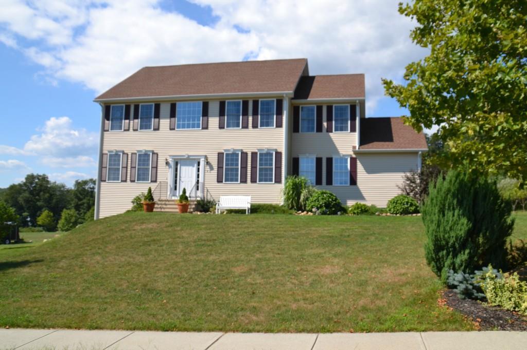 a front view of a residential apartment building with a yard