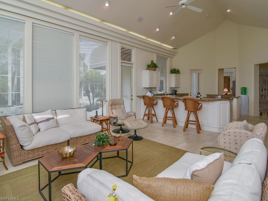 771 Brentwood Point Naples, FL 34110 - Photo 13 of 31 a living room with furniture and a large window
