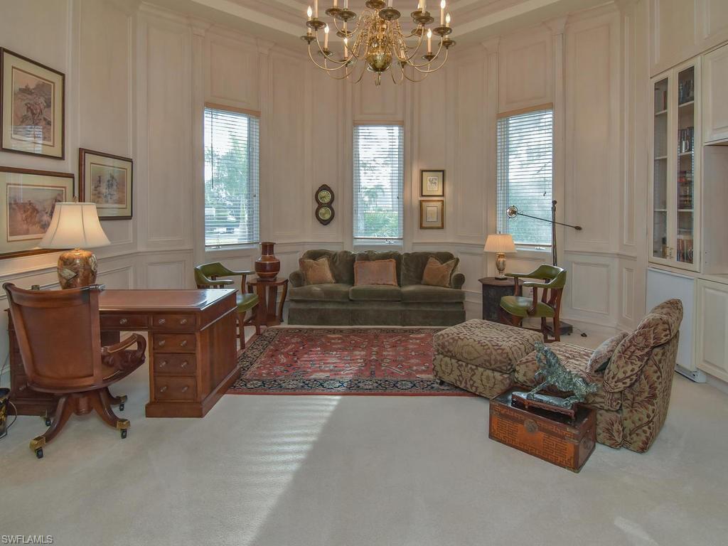 771 Brentwood Point Naples, FL 34110 - Photo 14 of 31 a living room with furniture and a chandelier