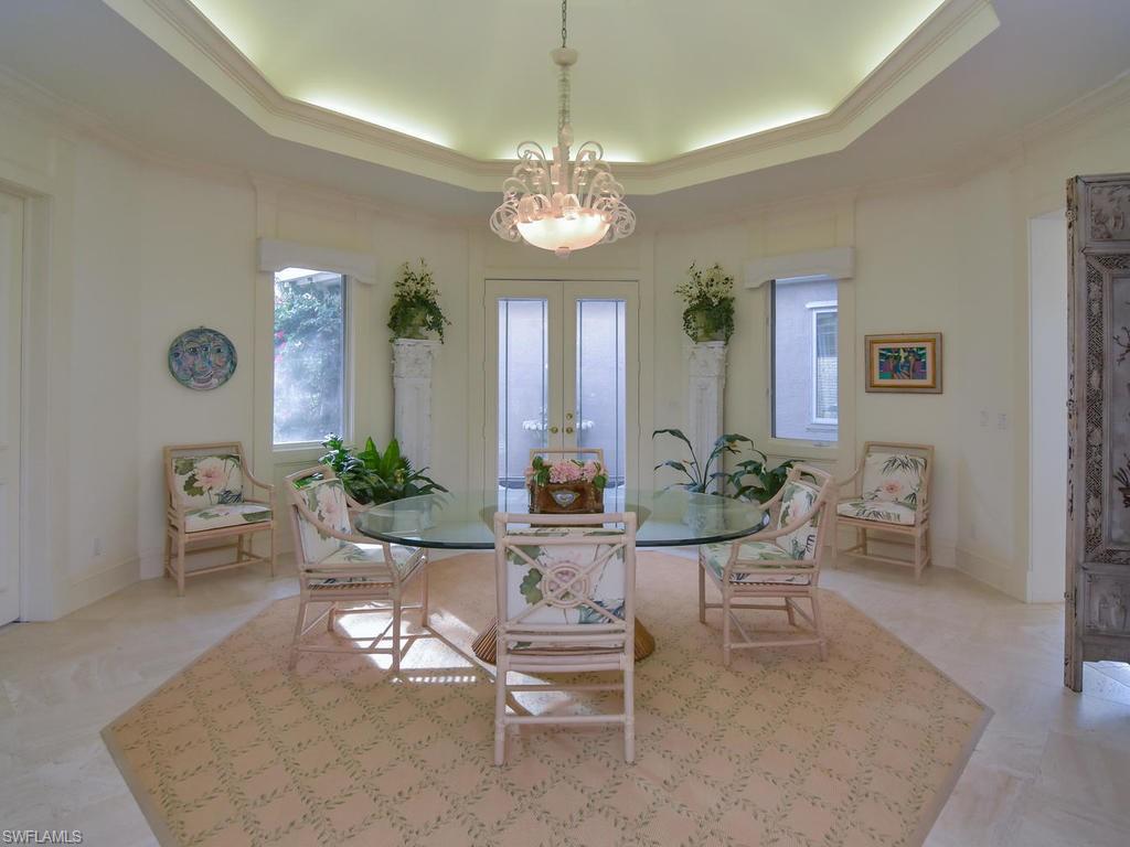 771 Brentwood Point Naples, FL 34110 - Photo 15 of 31 a view of a dining room with furniture and chandelier