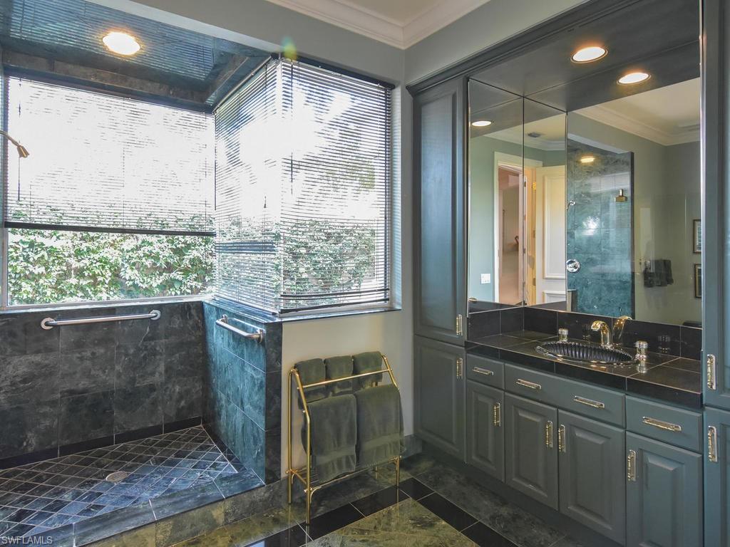 771 Brentwood Point Naples, FL 34110 - Photo 17 of 31 a bathroom with a granite countertop sink and a large mirror