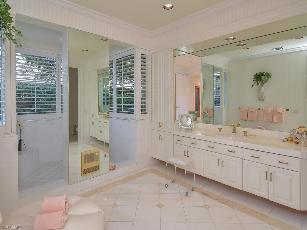 771 Brentwood Point Naples, FL 34110 - Photo 18 of 31 a spacious bathroom with a granite countertop sink a toilet a mirror and shower