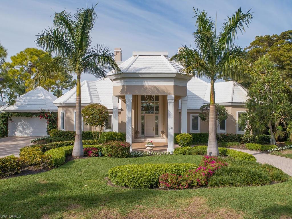 771 Brentwood Point Naples, FL 34110 - Photo 2 of 31 a front view of a house with a garden