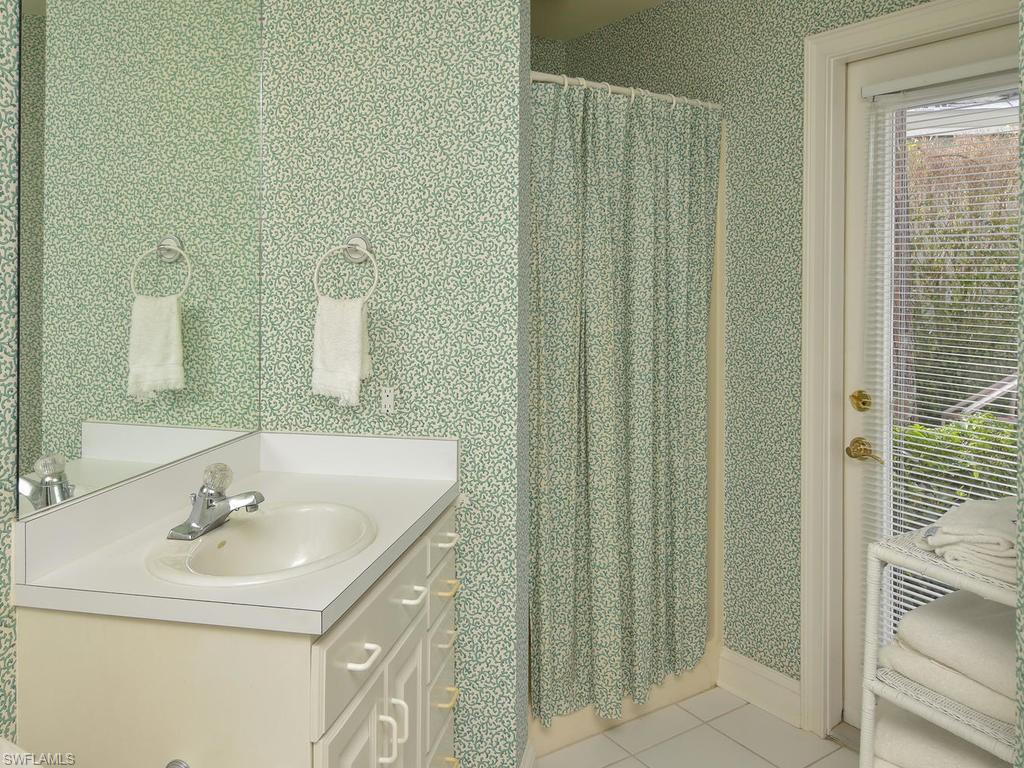 771 Brentwood Point Naples, FL 34110 - Photo 22 of 31 a bathroom with a sink and a mirror