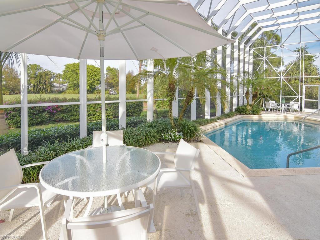 771 Brentwood Point Naples, FL 34110 - Photo 27 of 31 a swimming pool with outdoor seating and yard