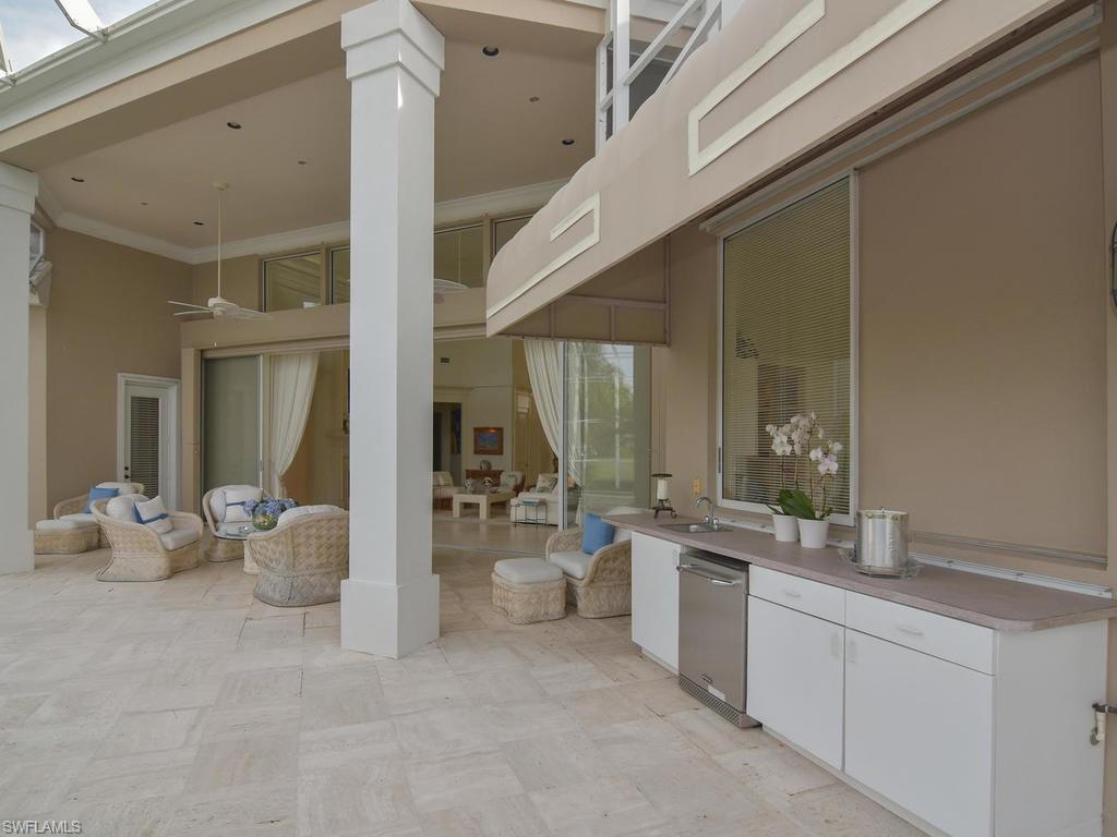 771 Brentwood Point Naples, FL 34110 - Photo 29 of 31 a large white kitchen with a large window and furniture