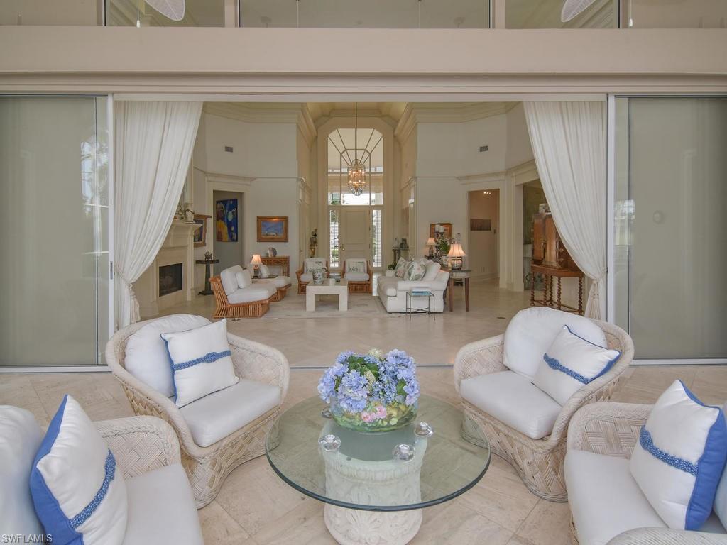 771 Brentwood Point Naples, FL 34110 - Photo 30 of 31 a living room with furniture and a fireplace