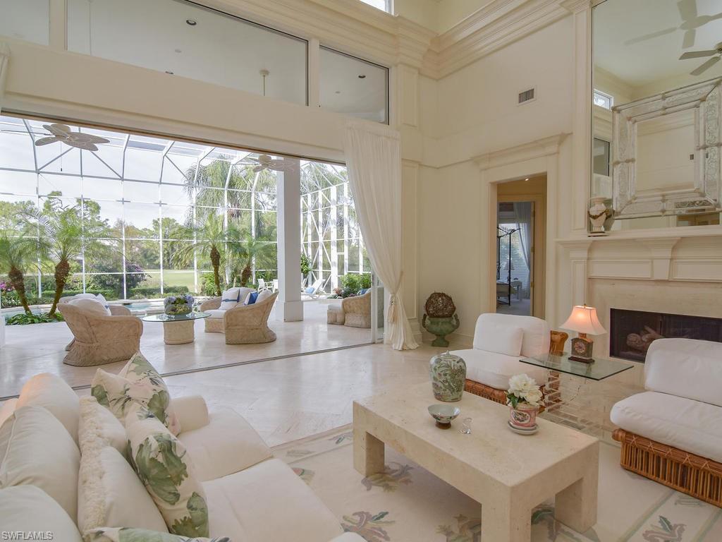771 Brentwood Point Naples, FL 34110 - Photo 6 of 31 a living room with fireplace furniture and a large window