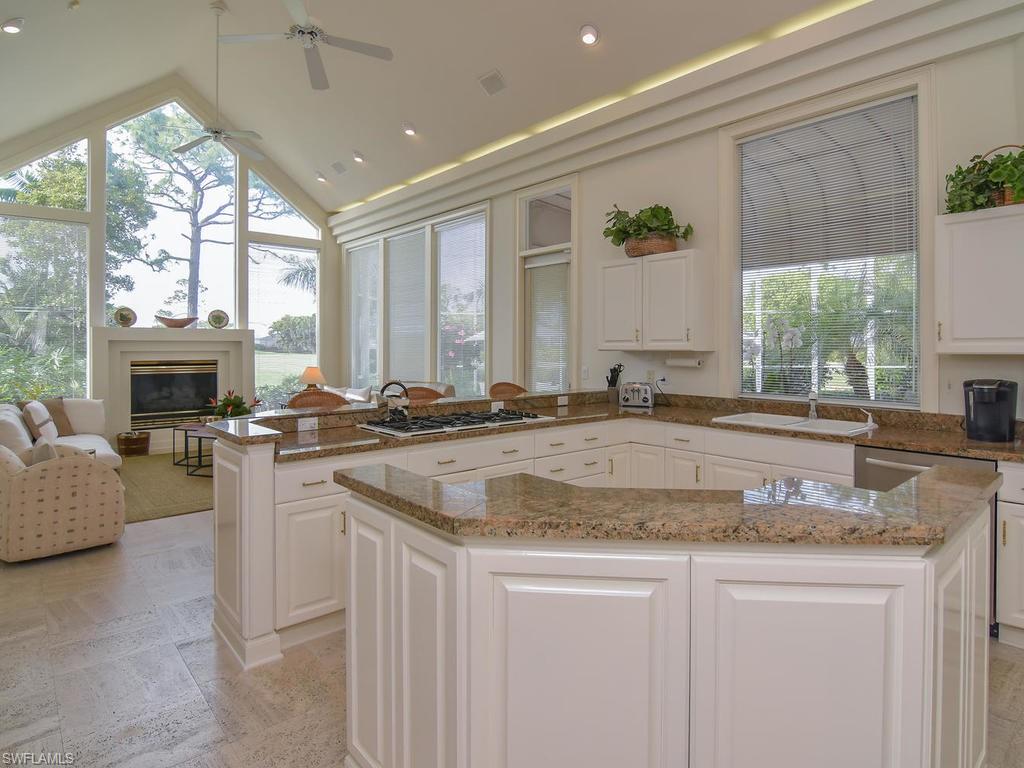 771 Brentwood Point Naples, FL 34110 - Photo 9 of 31 a view of living room with granite countertop furniture and fireplace