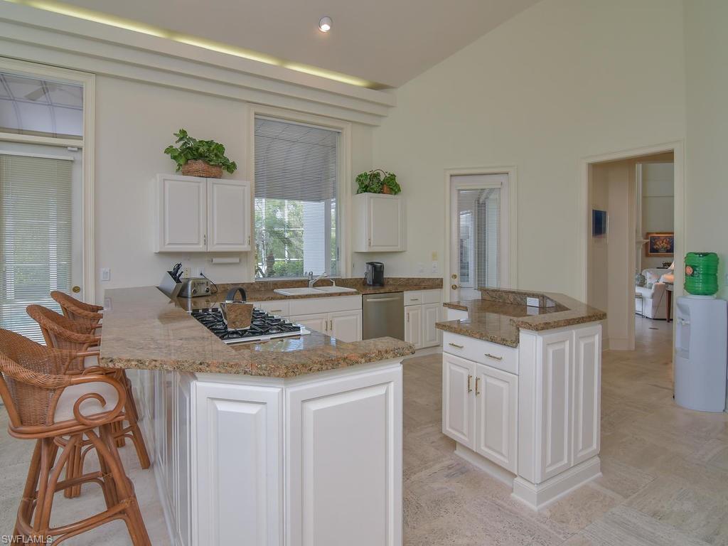 771 Brentwood Point Naples, FL 34110 - Photo 10 of 31 a kitchen with a sink stove and cabinets