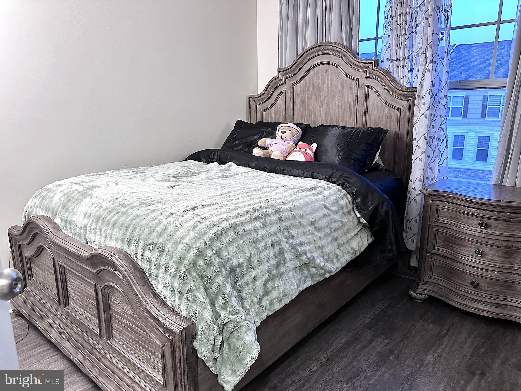 4718 Cambria Road Frederick, MD 21703 - Photo 14 of 32 a bed sitting in a bedroom next to a window