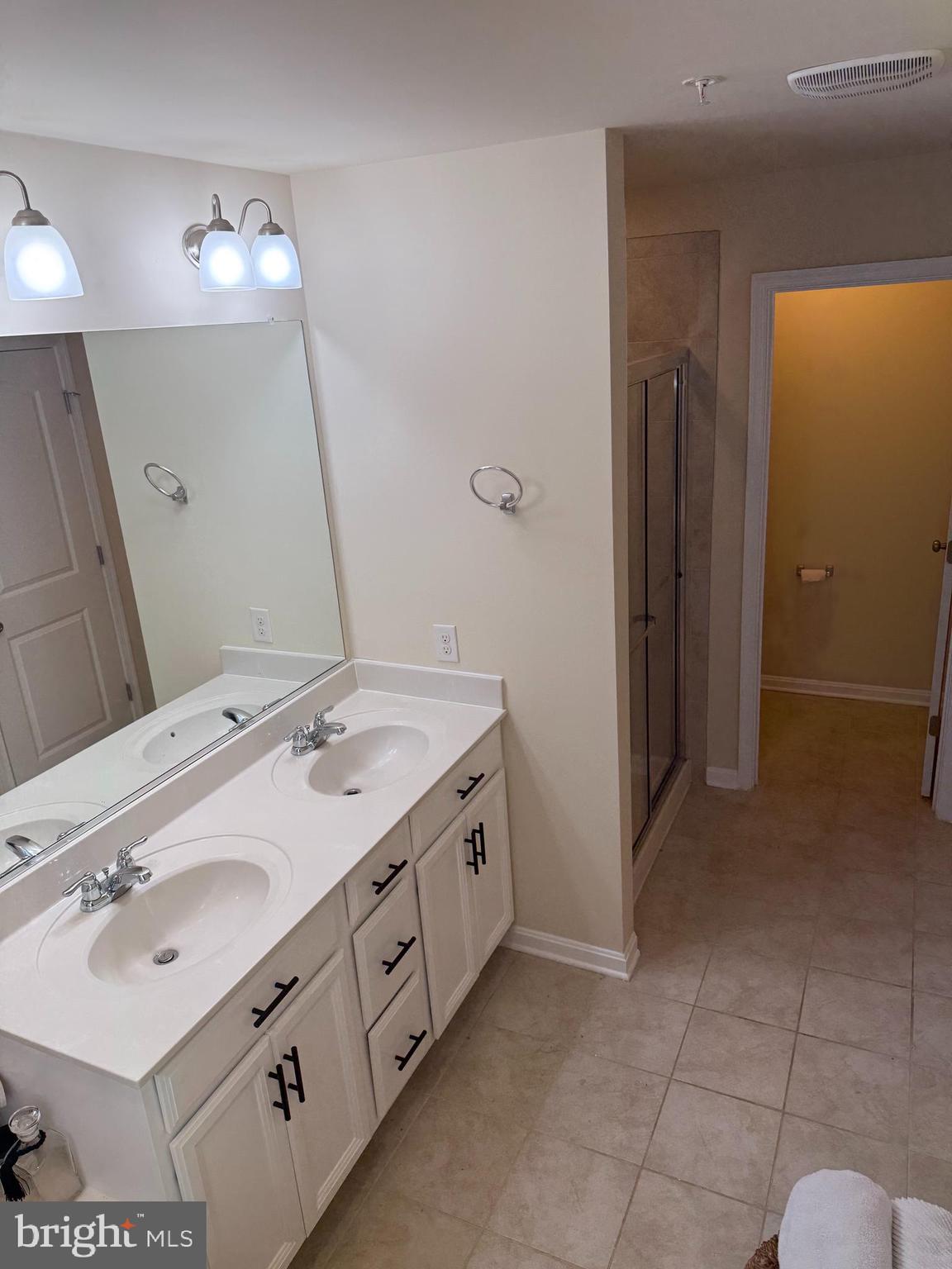 4718 Cambria Road Frederick, MD 21703 - Photo 17 of 32 a spacious bathroom with a double vanity sink and a mirror