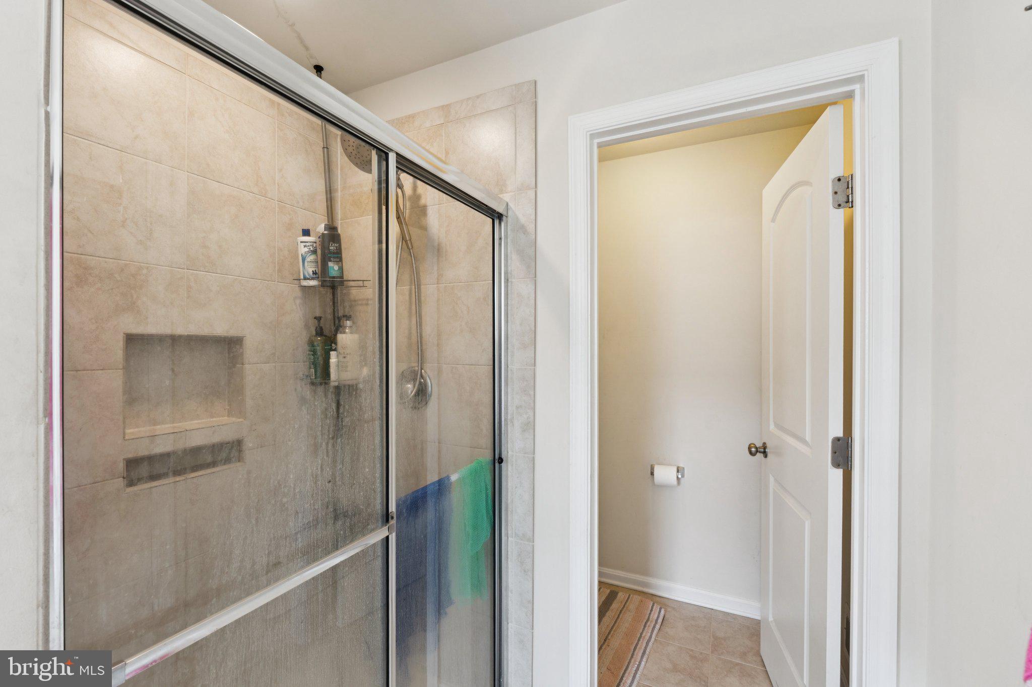 4718 Cambria Road Frederick, MD 21703 - Photo 18 of 32 a bathroom with a glass shower door
