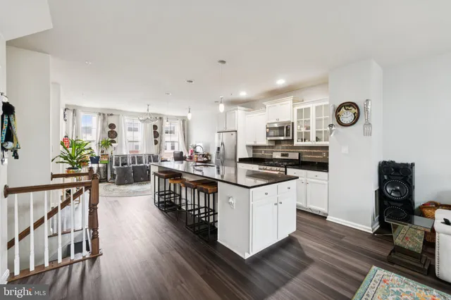 a kitchen with sink cabinets and wooden floor