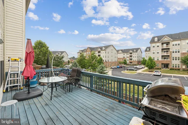 a view of a balcony with wooden floor and outdoor seating