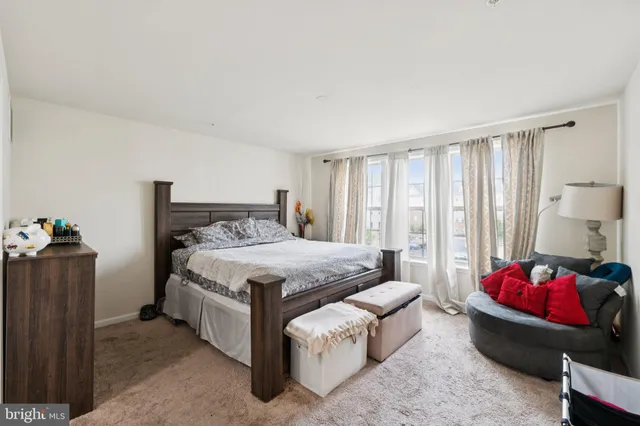 a spacious bedroom with a bed and a couch