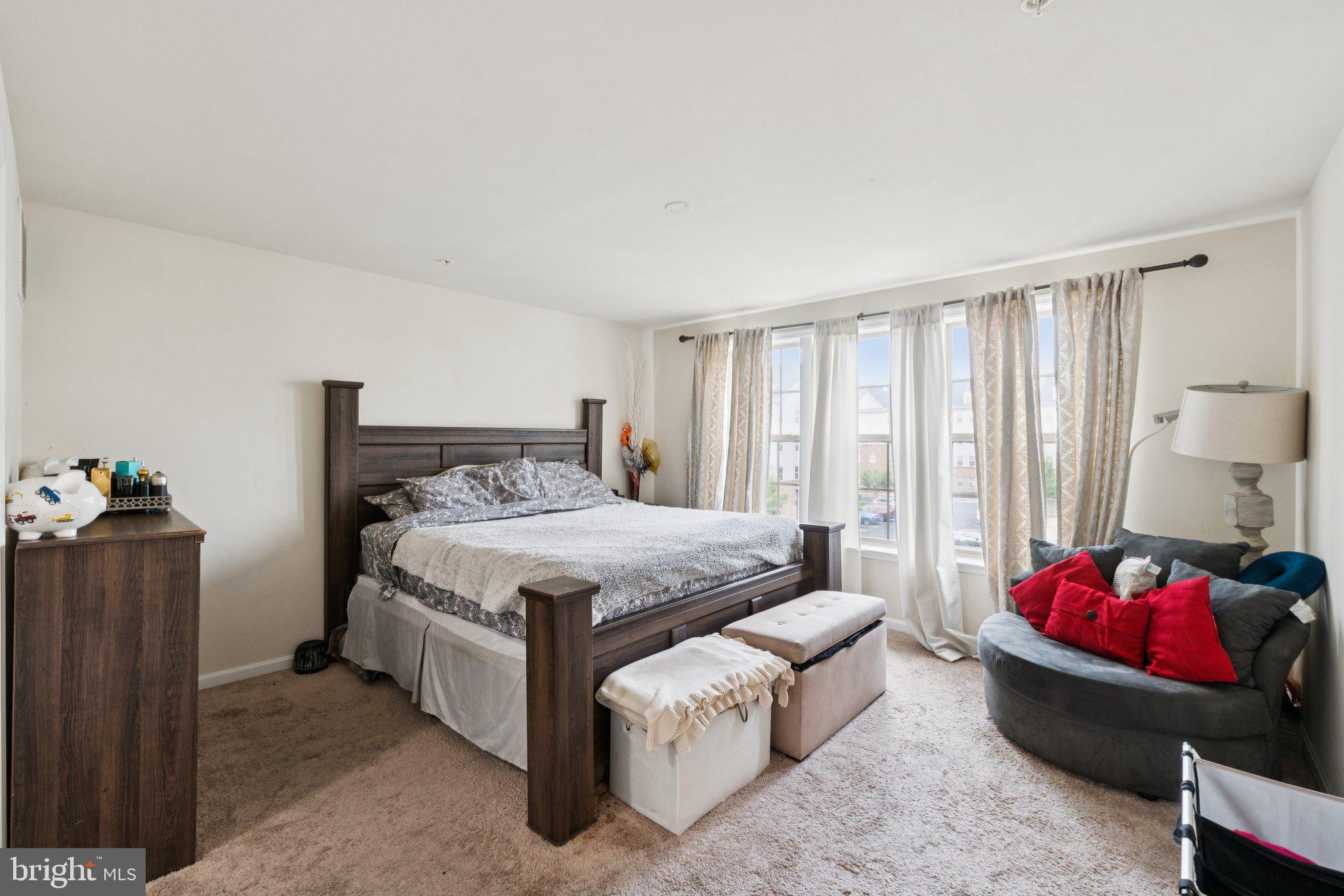 4718 Cambria Road Frederick, MD 21703 - Photo 10 of 32 a spacious bedroom with a bed and a couch