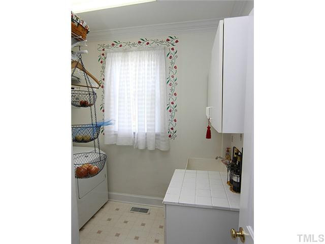 3404 Sir Colleton Court Raleigh, NC 27612 - Photo 12 of 25 Nice -size utility room with utility sink and cabinets. Laundry Room