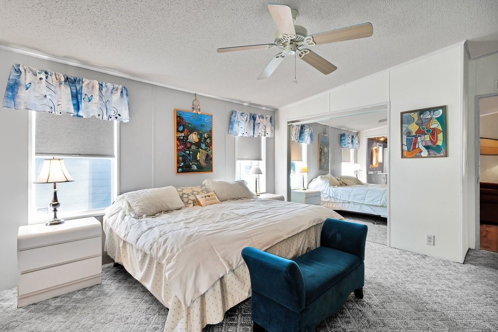 7605 Cedar Bark Road Sebastian, FL 32976 - Photo 15 of 34 a bedroom with a large bed couch and a window