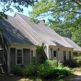 a aerial view of a house with a yard and potted plants