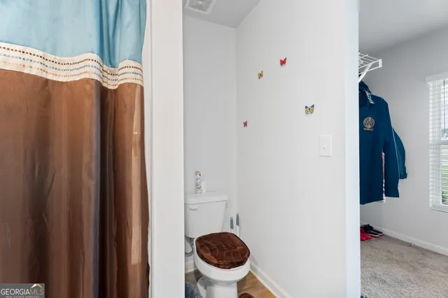 a en suite bathroom with a sink a toilet and shower