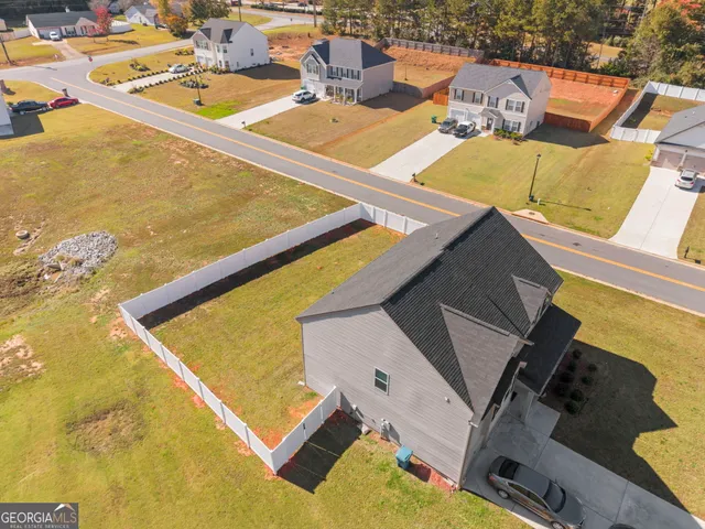 a view of a hallway with wooden floor and a bathroom