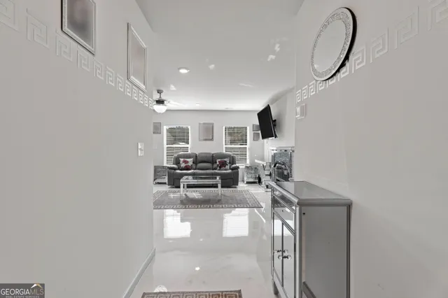 a living room with furniture kitchen view and a window