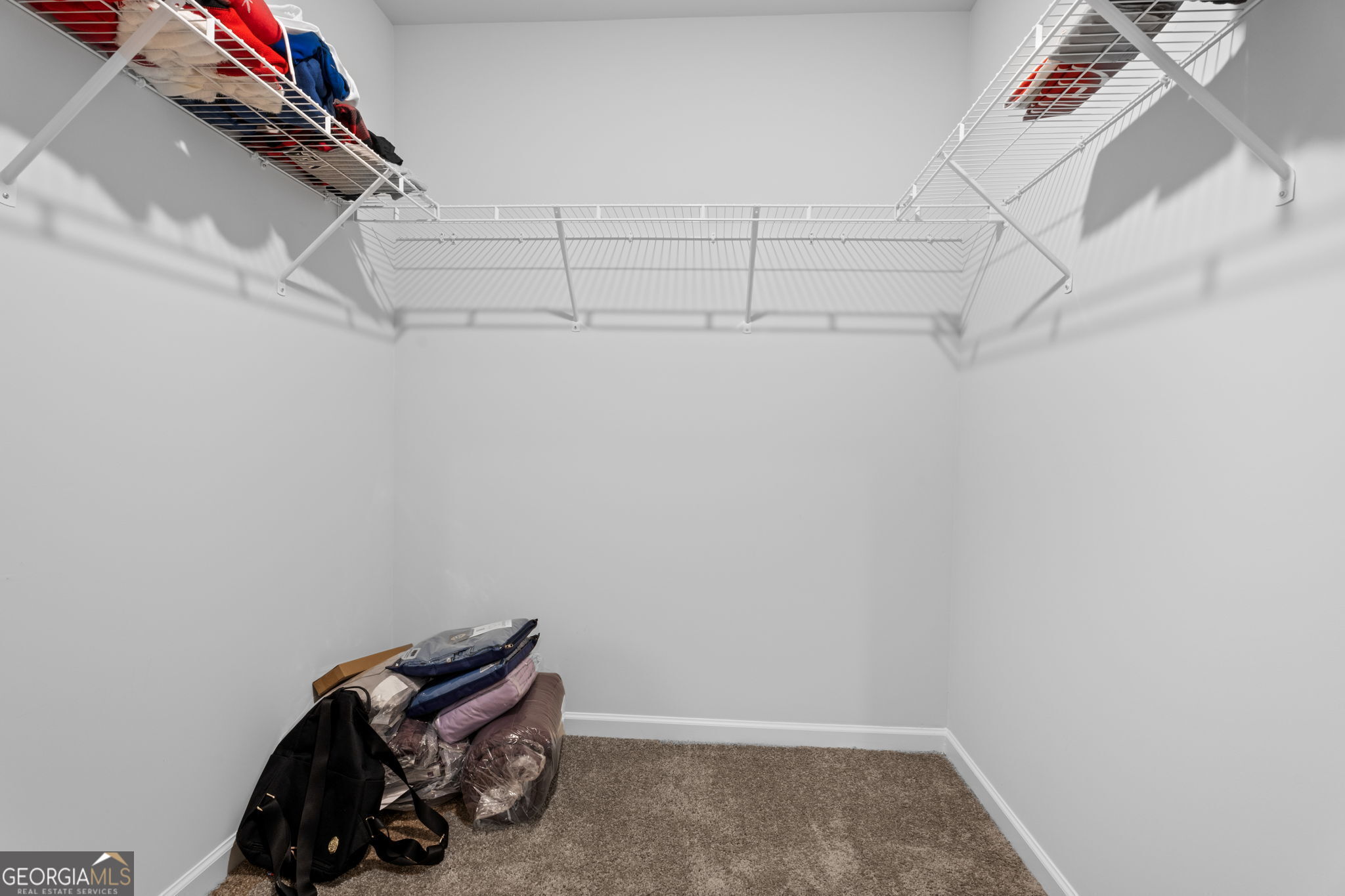 321 Kirt's Ridge Jackson, GA 30233 - Photo 41 of 57 a view of walk in closet with clothes and shoes